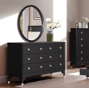 Hermin Modern Style Dresser Black Black dresser with silver knobs in a room setting with a mirror and decor items.
