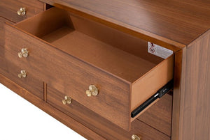  Wooden dresser with open drawer showing brass knobs on a white background
