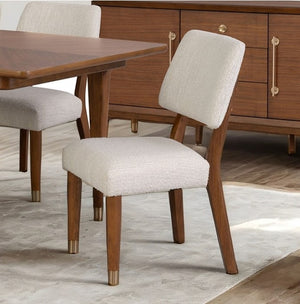 Hermin Modern Walnut Dining Chair Dining room with wooden table and chairs on a light wood floor.