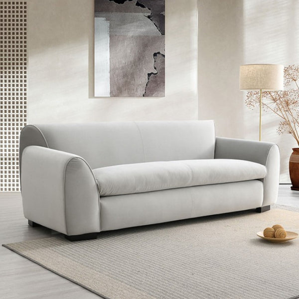 Karl Gray Contemporary Chenille Fabric Sofa Gray sofa in a modern living room with a lamp and abstract art on the wall.
