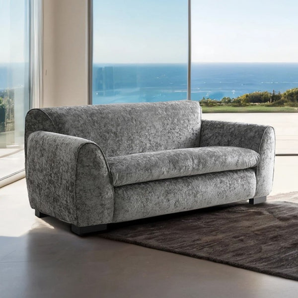 Karl Light Gray Contemporary Chenille Fabric Loveseat Gray sofa in a modern living room with large windows overlooking an ocean view.