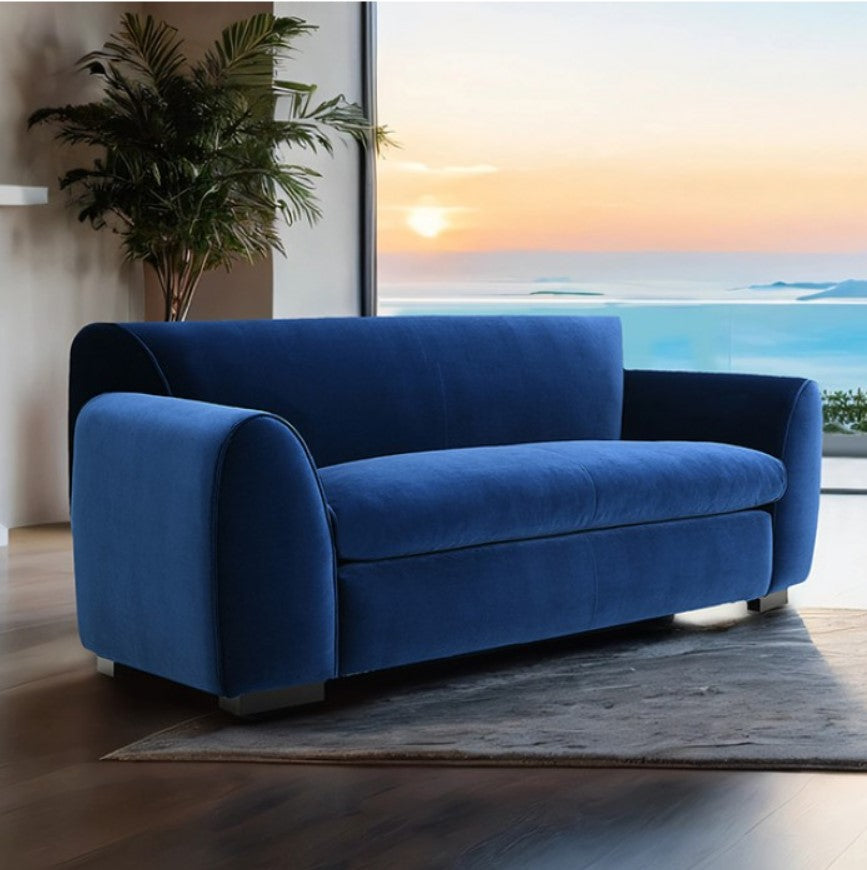Karl Royal Blue Contemporary Chenille Fabric Loveseat Blue sofa in a room with a large window showing a sunset over water.