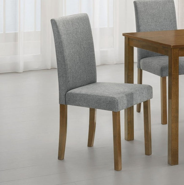 Kelsh High Back Oak Gray Upholstered Dining Chair Gray upholstered chairs with wooden legs in front of a wooden table on a light gray floor.