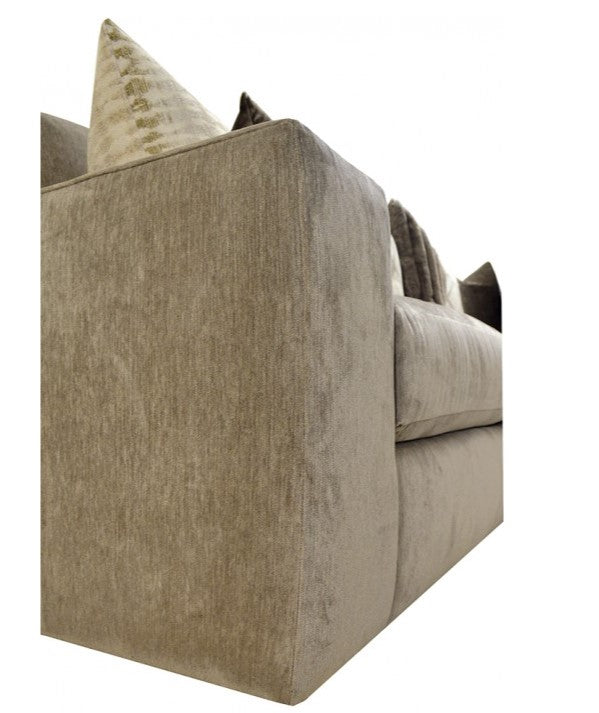 Beige sofa with decorative pillows on a white background