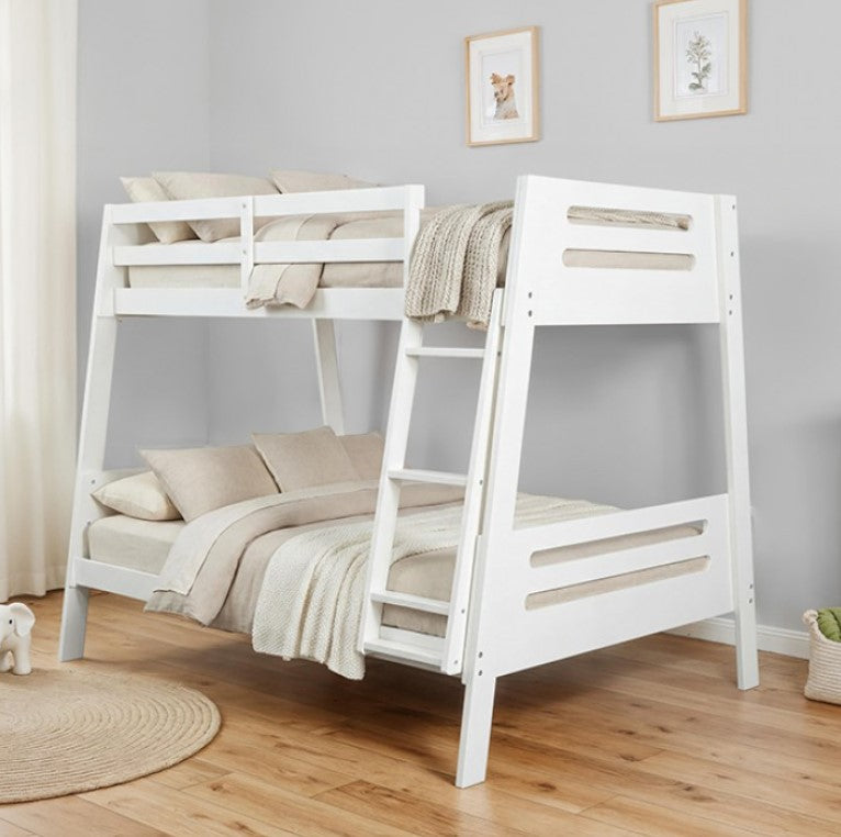 Kerran Bunkbed White Angled Twin Full White wooden bunk bed with beige bedding in a room with light gray walls and wooden flooring.