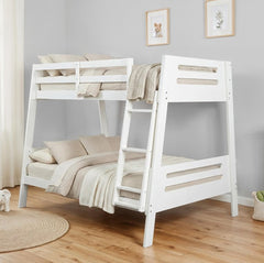 Kerran Bunkbed White Angled Twin Full White wooden bunk bed with beige bedding in a room with light gray walls and wooden flooring.