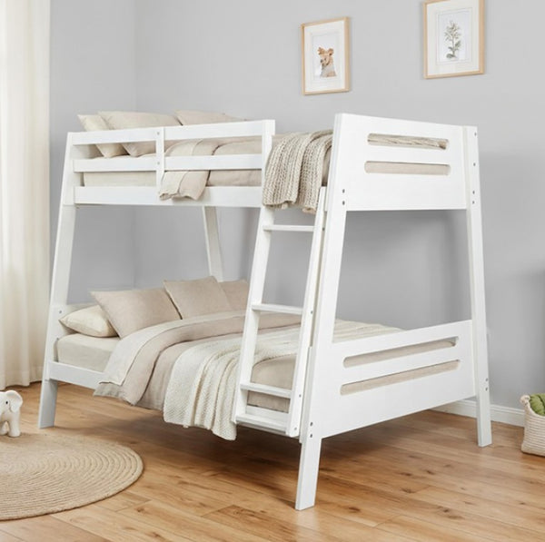 Kerran Bunkbed White Angled Twin Full White wooden bunk bed with beige bedding in a room with light gray walls and wooden flooring.