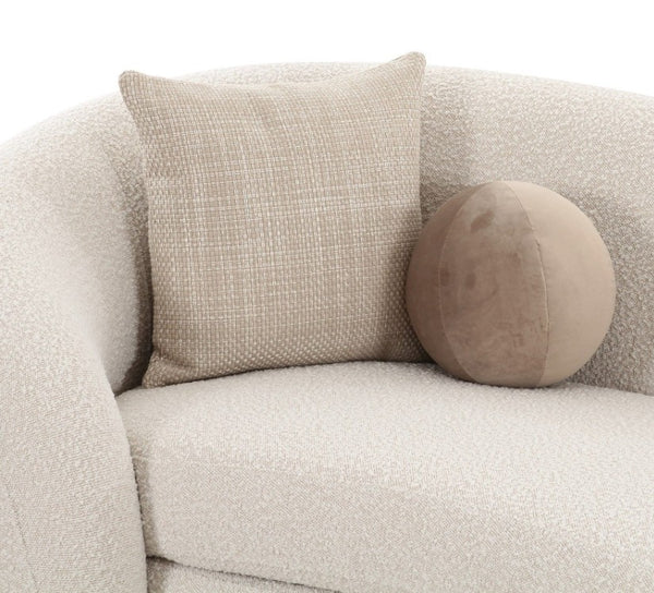 Kilmer Off White Fabric Curved Modern Sectional Sofa A textured beige throw pillow and a round taupe velvet lumbar pillow displayed on a cream boucle armchair against a white background.