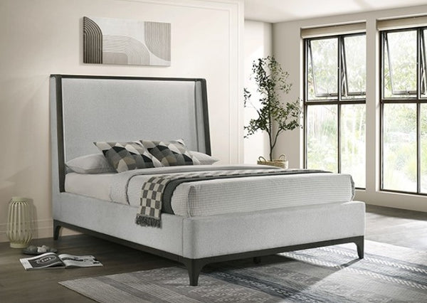 Kladirmen Wingback Panel Fabric Upholstered Bed Modern bedroom with a gray upholstered bed, striped bedding, and large windows.