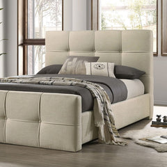 Koall Ivory Fabric Biscuit Button Tufting Bed Beige upholstered bed with gray bedding in a room with large windows.