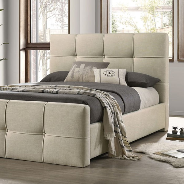 Koall Ivory Fabric Biscuit Button Tufting Bed Beige upholstered bed with gray bedding in a room with large windows.