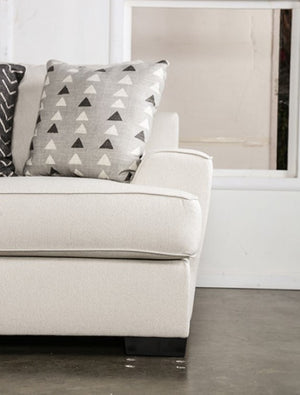 Kriska Light Gray Fabric Sofa with Pillows Beige sofa with patterned cushions against a white wall.