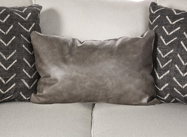 Kriska Light Gray Fabric Sofa with Pillows Gray textured pillow on a light gray couch with two patterned pillows.