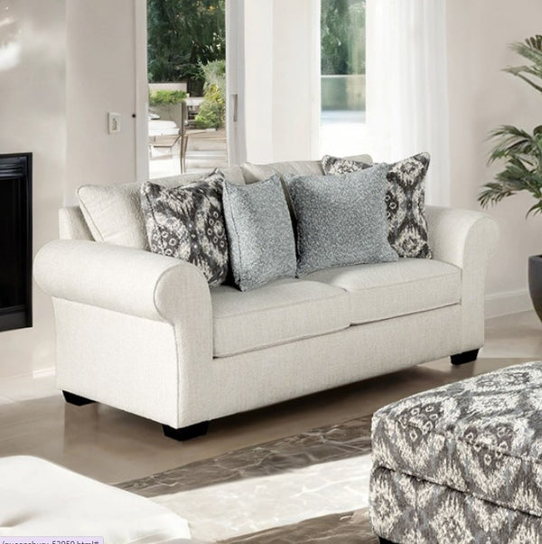 Kumar Rolled Arm White Fabric Loveseat White sofa with patterned cushions in a living room setting