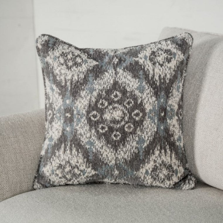 Kumar Rolled Arm White Fabric Loveseat White sofa with patterned cushions in a living room setting