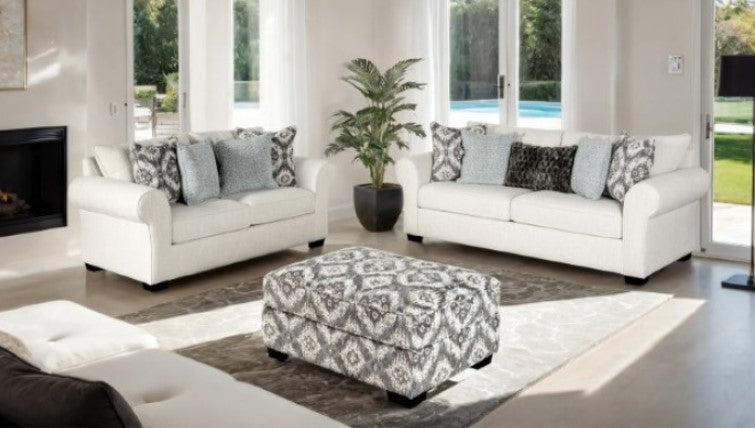 Kumar Transitional White-Gray Fabric Ottoman Patterned ottoman in a living room setting with a couch and chair.