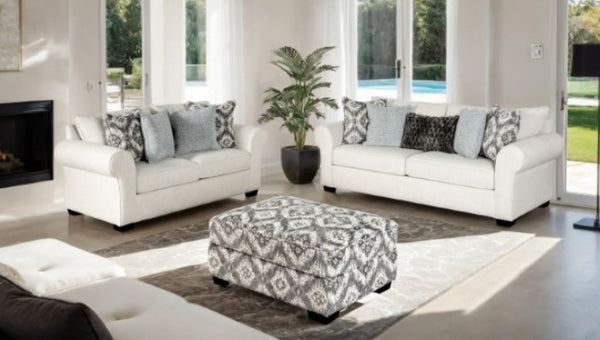 Kumar Rolled Arm White Fabric Sofa Living room with white sofas, patterned ottoman, and decorative pillows.