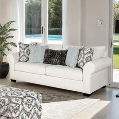 Kumar Rolled Arm White Fabric Sofa White sofa with patterned cushions in a living room with large windows.