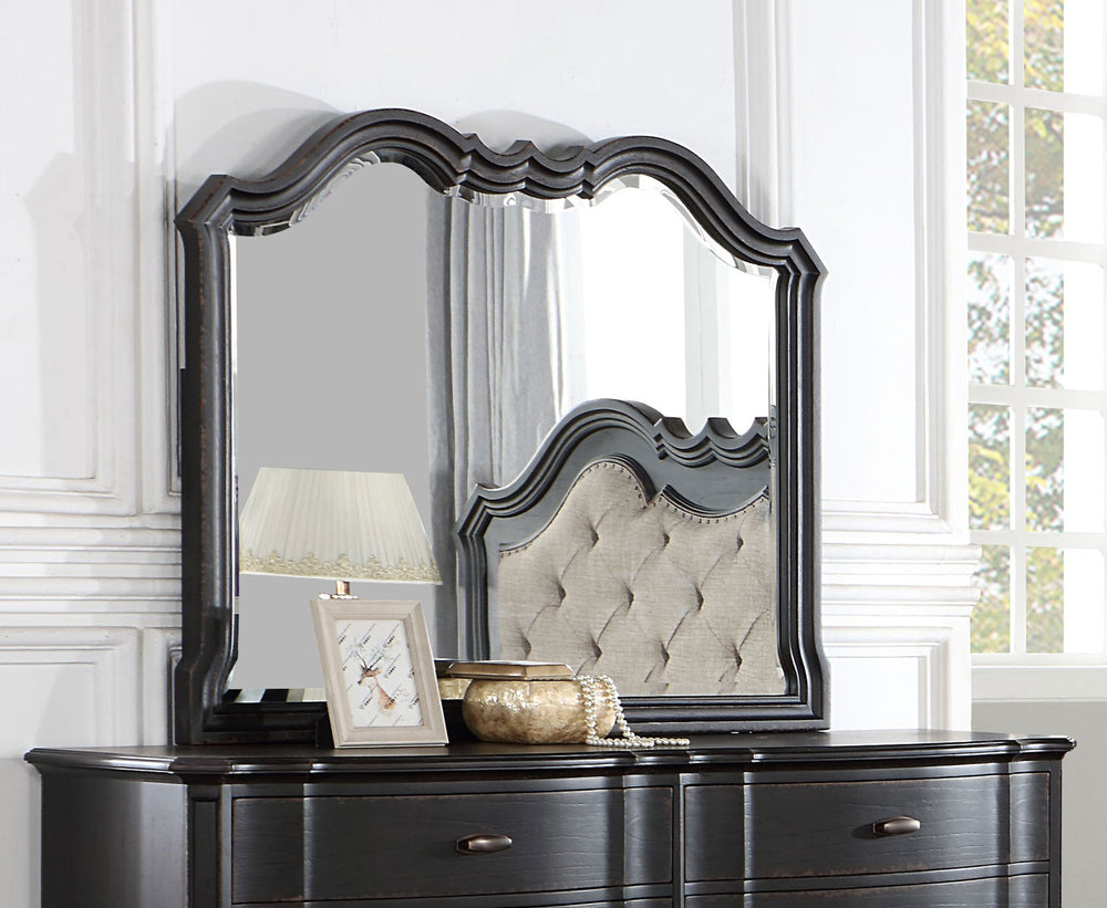 Lesley Camel Back Mirror A dark wood dresser with an attached arched mirror, styled in a bright room with a window, lamp, and decorative items.