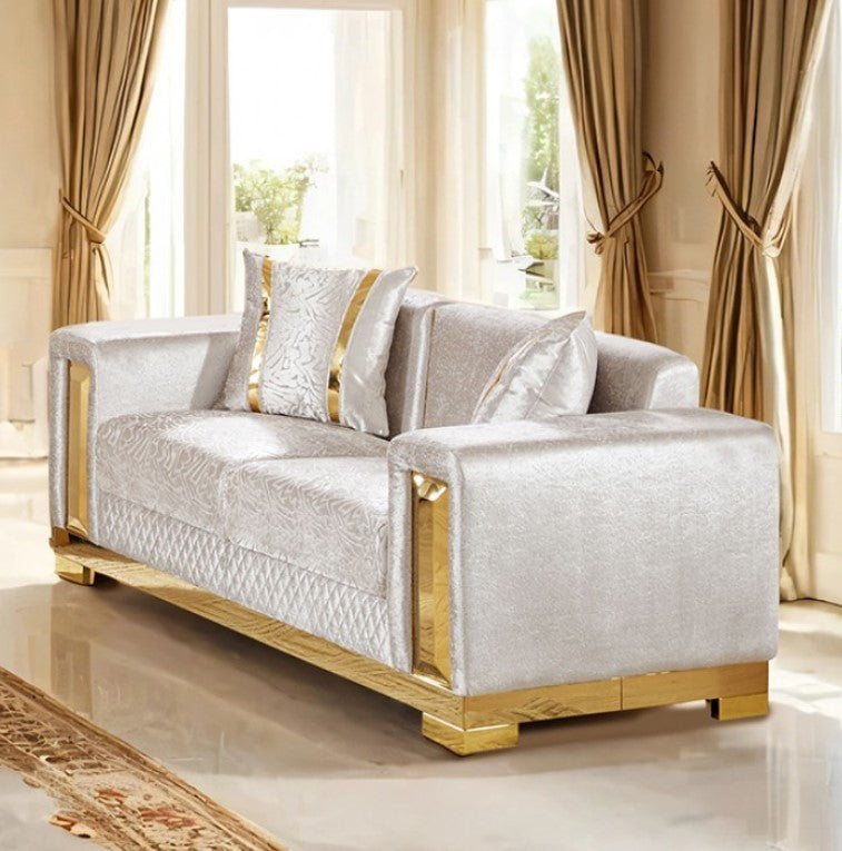 Lika Glam Beige Loveseat Gold Trims Luxurious beige sofa with gold accents in a room with large windows and curtains.