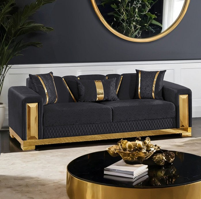 Lika Glam Black Sofa Gold Trims Modern living room with a black sofa and gold accents, featuring a round mirror and decorative items.