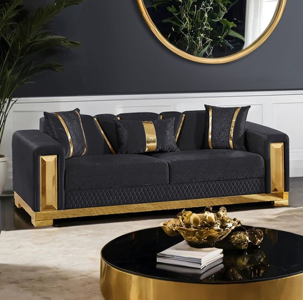 Lika Glam Black Sofa Gold Trims Modern living room with a black sofa and gold accents, featuring a round mirror and decorative items.