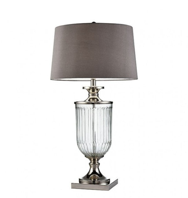 Lizzi Table Lamp Silver Clear Translucent Vase A table lamp with a gray fabric drum shade, a clear ribbed glass urn-shaped body, and polished silver-toned metal accents on a white background.