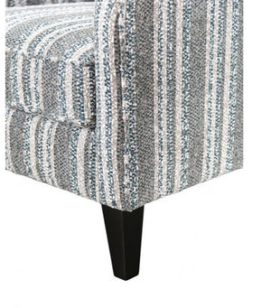 Patterned upholstered chair with a black leg on a white background