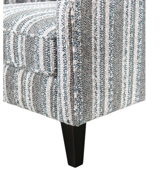 Patterned upholstered chair with a black leg on a white background