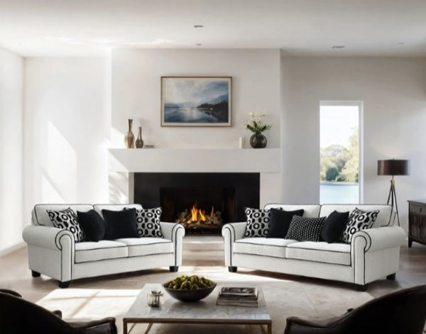 Logen White Chenille Fabric Sofa With Pillows Set Modern living room with white sofas, a fireplace, and decorative items.
