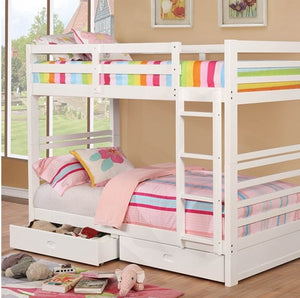 Lukka Twin Twin White Storage Drawers Bunkbed White bunk bed with colorful bedding in a room with large windows.