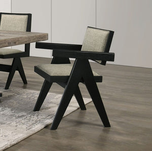 Maeve Contemporary Black Finish Dining Arm Chair Modern black chair with gray cushion on a wooden floor