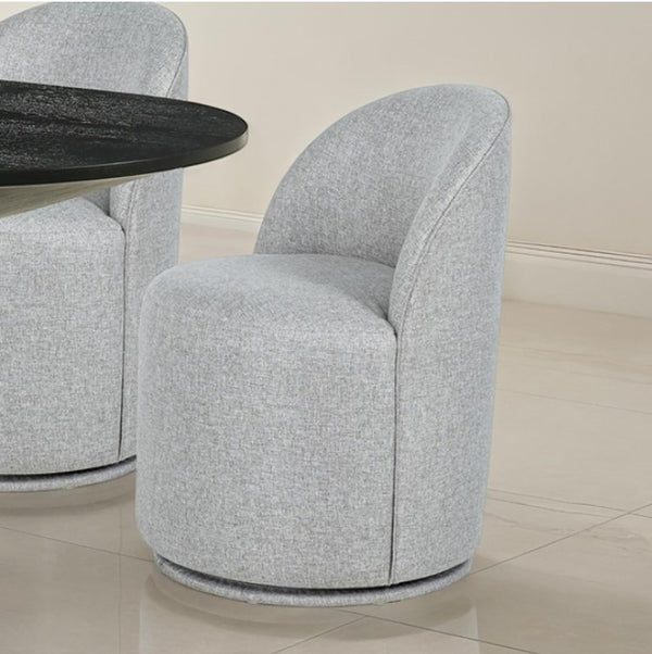Maeve Contemporary Taupe Fully Upholstered Swivel Chair Gray upholstered chairs with a round black table on a light wood floor.