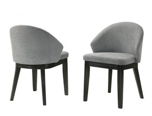 Maeve Organic Modern Black Finish Dining Chair Two gray upholstered chairs with black legs on a white background