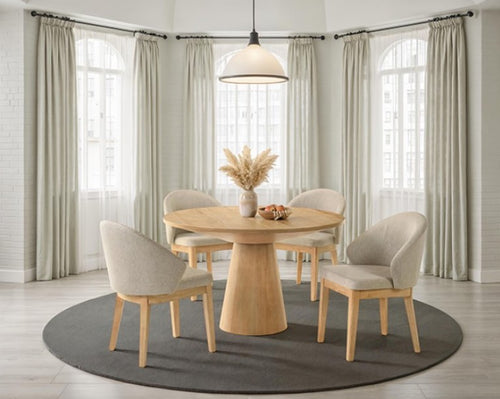 Maeve Round 48" Contemporary Oak Finish Dining Table Dining room with wooden table and chairs in a well-lit room.