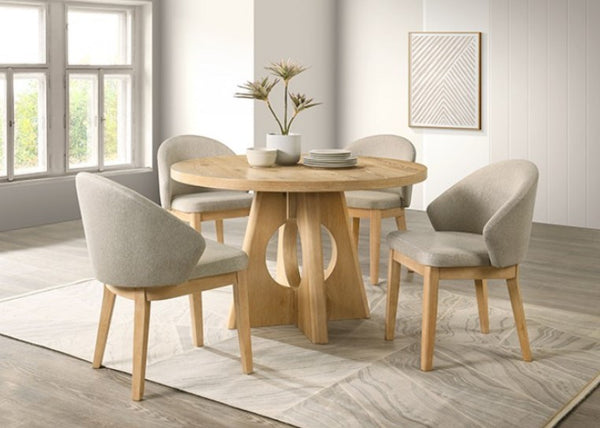 Maeve Round Organic Modern Oak Finish Dining Table Dining room with wooden table and chairs in a bright room.
