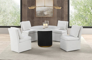 Maeve White Contemporary Modern Style Dining Chair A modern 5-piece dining set featuring a round white marble-top table with a black cylindrical pedestal base and gold trim, surrounded by four white upholstered club chairs in a bright, contemporary dining room.