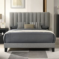 Maltari Contemporary Fully Upholstered Fabric Bed Gray upholstered bed in a bedroom setting with a headboard and pillows.