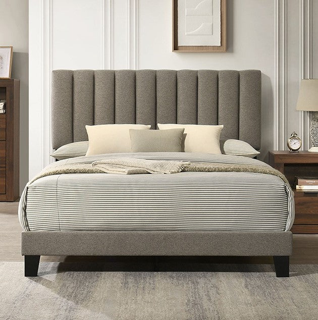Maltari Contemporary Fully Upholstered Walnut Fabric Bed Gray upholstered bed with striped bedding in a bedroom setting.