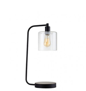 Massi Contemporary Black Metal Clear Shade Table Lamp A modern table lamp with a matte black metal frame, a clear glass cylinder shade, and a visible warm Edison-style bulb, set against a plain white background.