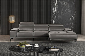 Matteo Modern Style Dark Gray Adjustable Headrest Leather Sectional Sofa Gray leather sectional sofa in a modern living room with marble coffee table and wall.