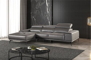 Matteo Modern Style Dark Gray Adjustable Headrest Leather Sectional Sofa Gray leather sectional sofa in a modern living room with a marble accent wall.