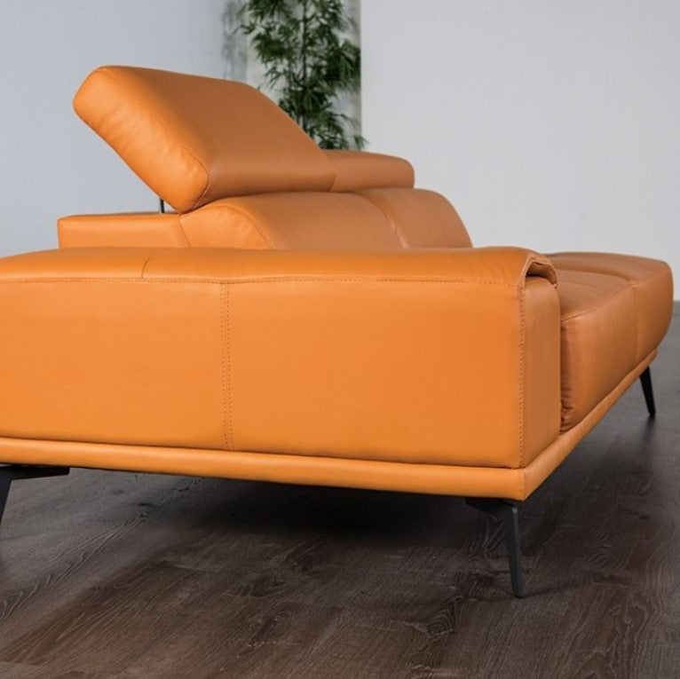 Matteo Modern Style Tangerine Adjustable Headrest Leather Sectional Sofa Brown leather sectional sofa in a modern living room with a marble wall and glass coffee table.