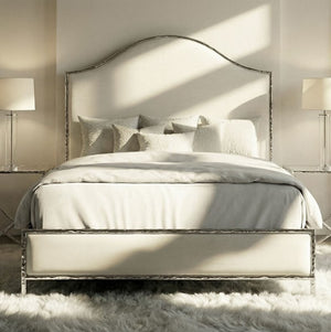 Melan Fabric Chrome Metal Two Tone Bed Neatly made bed with decorative pillows in a bedroom setting