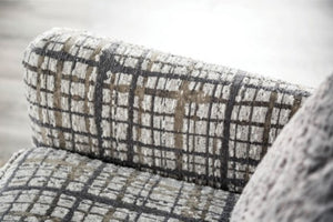 Mercia Sloped Track Arm Accent Chair Plaid patterned chair with a blurred background