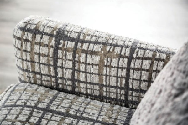 Mercia Sloped Track Arm Accent Chair Plaid patterned chair with a blurred background