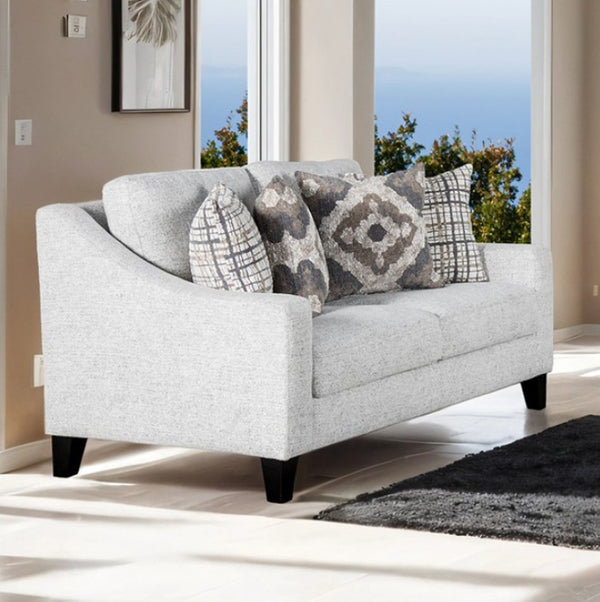 Mercia Sloped Track Arm Loveseat 
Gray Loveseat with patterned cushions in a living room setting
