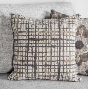 Plaid patterned pillow on a sofa