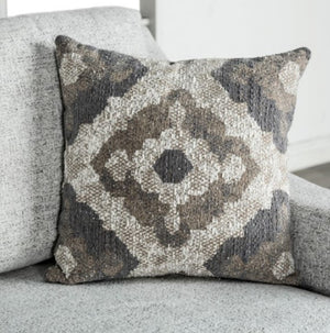 Decorative pillow with a geometric pattern on a gray sofa