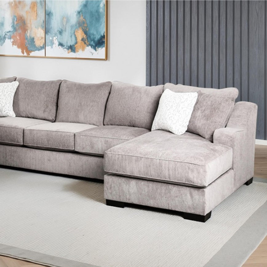 Mika Oversized Transitional Style Sectional Sofa Gray sectional sofa in a living room with abstract art on the wall.